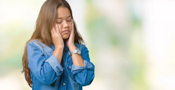 Young beautiful brunette woman wearing blue denim shirt over isolated background Tired hands covering face, depression and sadness, upset and irritated for problem