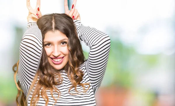 Young Beautiful Woman Wearing Stripes Sweater Posing Funny Crazy Fingers — Stock Photo, Image