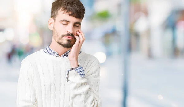 Young handsome man wearing winter sweater over isolated background thinking looking tired and bored with depression problems with crossed arms.