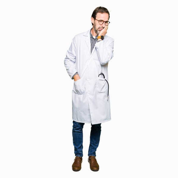 Middle age doctor men wearing medical coat thinking looking tired and bored with depression problems with crossed arms.