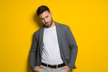 Yakışıklı delikanlı possing ve izole sarı arka plan üzerinde modelleme