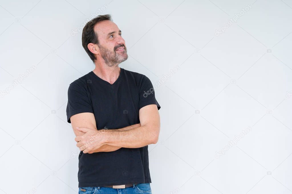 Senior man over isolated background smiling looking to the side with arms crossed convinced and confident