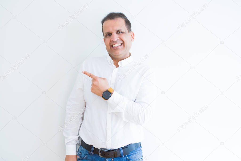 Middle age business man smiling and pointing to the side over white background