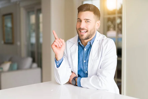 Young Handsome Doctor Man Clinic Big Smile Face Pointing Hand — Stock Photo, Image