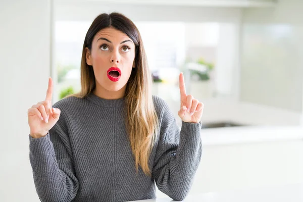 Jovem Mulher Bonita Vestindo Suéter Inverno Casa Espantado Surpreso Olhando — Fotografia de Stock