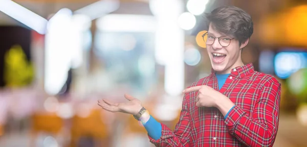 Jovem Homem Bonito Vestindo Óculos Sobre Fundo Isolado Espantado Sorrindo — Fotografia de Stock