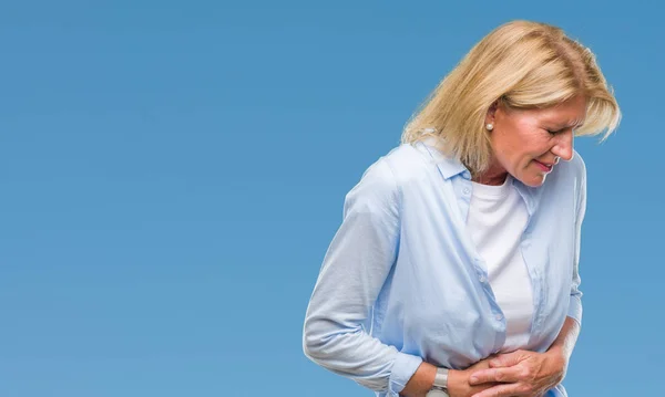 Middle age blonde woman over isolated background with hand on stomach because nausea, painful disease feeling unwell. Ache concept.