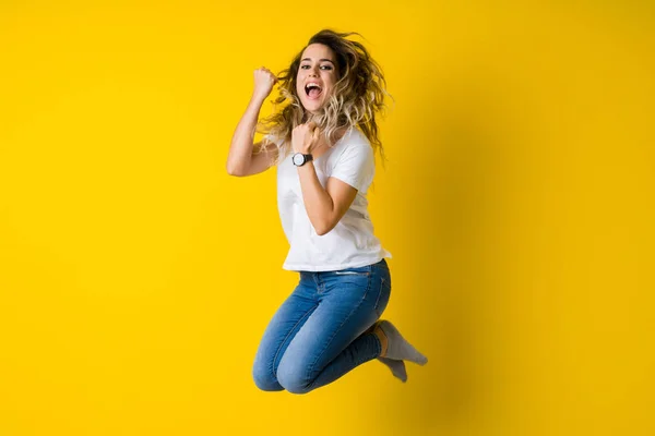 Beautiful Young Blonde Woman Jumping Happy Excited Hanging Upside Isolated  Stock Photo by ©Krakenimages.com 231735854