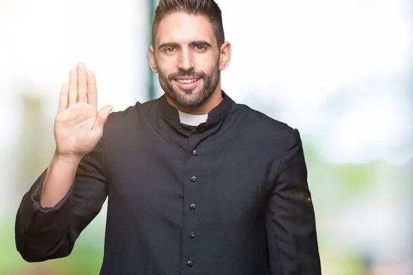 Young Christian Priest Isolated Background Waiving Saying Hello Happy Smiling — Stock Photo, Image