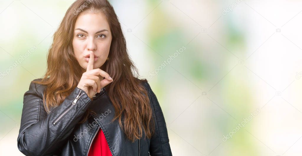 Beautiful plus size young woman wearing a fashion leather jacket over isolated background asking to be quiet with finger on lips. Silence and secret concept.