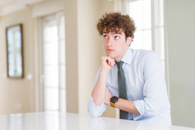 Çene düşünme hakkında soru, dalgın ifade üzerine el ile kravat giyen genç iş adamı. Düşünceli yüzüyle gülümsüyor. Şüphe kavramı.