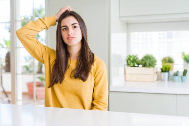 Sarı kazak giyen güzel genç kadın yanıltır ve soru hakkında merak ediyorum. Şüphe, kafasına el ile düşünme ile belirsiz. Dalgın kavramı.