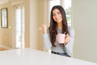 Genç kadın gurur çığlık ve zafer ve başarı çok heyecanlı, kutluyor kahve içme duygu tezahürat
