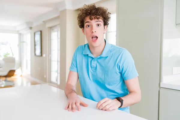 Joven Hombre Guapo Con Camiseta Azul Casual Casa Asustado Sorprendido —  Fotos de Stock