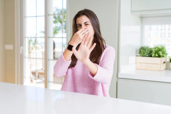 Beautiful Young Woman Wearing Pink Sweater Smelling Something Stinky Disgusting — Stock Photo, Image