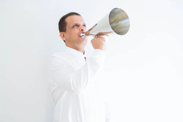 Middle age man shouting through a megaphone — Stock Photo, Image