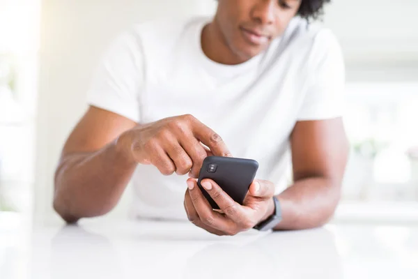 Close up of african american man hands using smartphone and smil — Stock Photo, Image