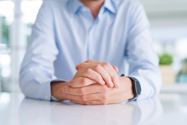 Close up de homem cruzou as mãos sobre a mesa branca — Fotografia de Stock