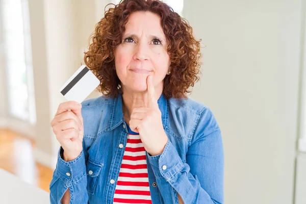 Senior Woman Holding Credit Card Payment Serious Face Thinking Question — Stock Photo, Image