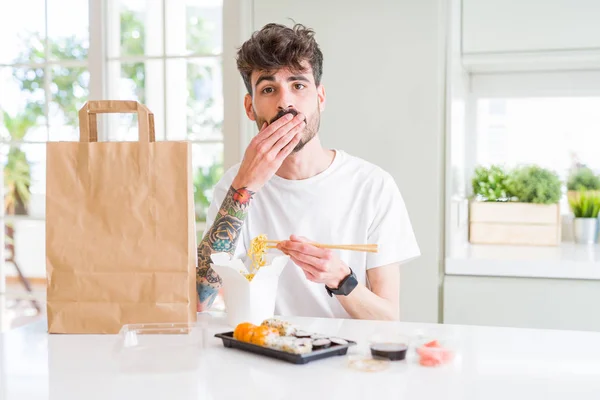 Młody Mężczyzna Jedzenie Sushi Azjatycki Dostawa Domu Pokrywa Usta Ręką — Zdjęcie stockowe