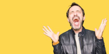 Orta yaş yakışıklı adamın siyah deri ceket kızgın ve silah ile başarı için deli kutluyor giydiğini kaldırdı ve heyecanlı çığlık gözler kapalı. Kazanan kavramı