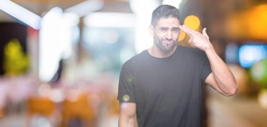 İzole genç yakışıklı adam arka plan çekim ve öldürmek kendini el ve parmaklara baş, intihar jest işaret.