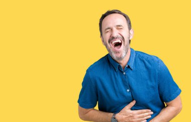 Yakışıklı orta yaş zarif komuta sizde izole üzerinde arka plan gülen ve komik deli şaka çünkü yüksek sesle zor gülüyor. Mutlu ifade.