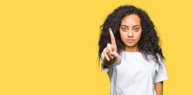 Kıvırcık saç kadar rahat beyaz t-shirt işaret parmağınızla giyen ve kızgın ifade ile genç güzel kız