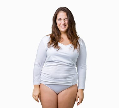 Artı boyutu genç overwight kadın güzel üzerinde beyaz iç çamaşırı giyiyor arka plan seksi bir ifadeyle, neşeli ve mutlu yüzünü kameraya bakarak göz kırpıyor izole.