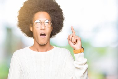 Afrikalı-Amerikalı genç afro saçlı gözlüklü başarılı fikirle parmak işaret. Çıktıktan ve mutlu. Bir numara.