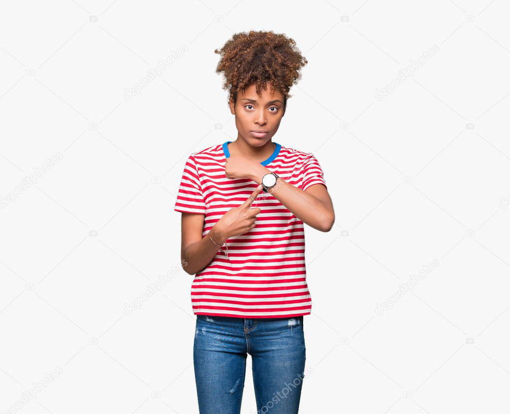 Beautiful young african american woman over isolated background In hurry pointing to watch time, impatience, upset and angry for deadline delay