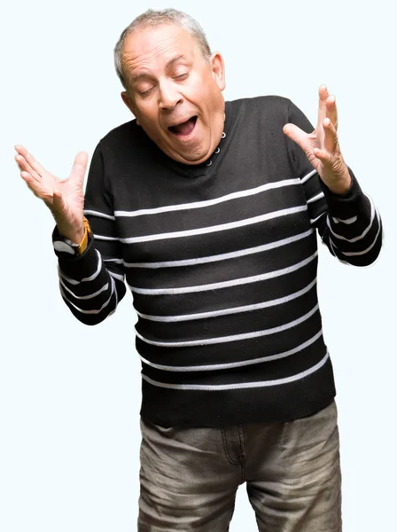Handsome Senior Man Wearing Winter Stripes Sweater Celebrating Mad Crazy — Stock Photo, Image