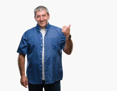 Seyir ve başparmak yanında yukarıyı mutlu yüz ile gülümseyen izole arka plan üzerinde üst düzey yakışıklı.