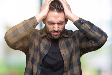 Yakışıklı delikanlı çünkü umutsuz ve stresli baş ağrısı acı izole arka plan üzerinde ağrı ve migren. Ellerini kafasına.