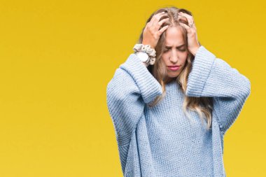 Çünkü çaresiz ve stresli baş ağrısı acı izole arka plan üzerinde kış kazak giyen güzel sarışın genç kadın acı ve migren. Ellerini kafasına.