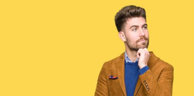 Genç yakışıklı iş adamı çene düşünme hakkında soru, dalgın ifade üzerine el ile. Düşünceli yüzüyle gülümsüyor. Şüphe kavramı.