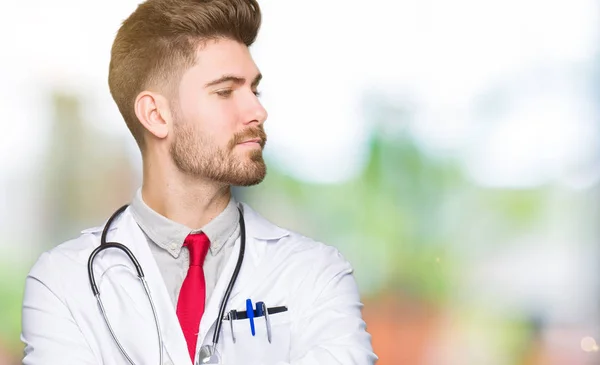 Young Handsome Doctor Man Wearing Medical Coat Smiling Looking Side — Stock Photo, Image