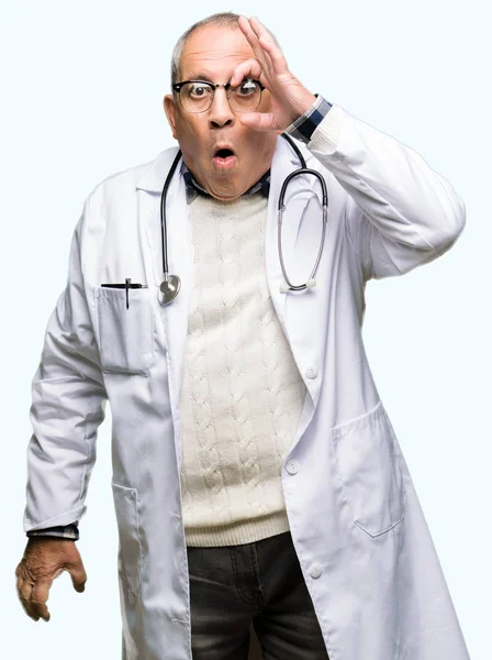Handsome Senior Doctor Man Wearing Medical Coat Doing Gesture Shocked — Stock Photo, Image