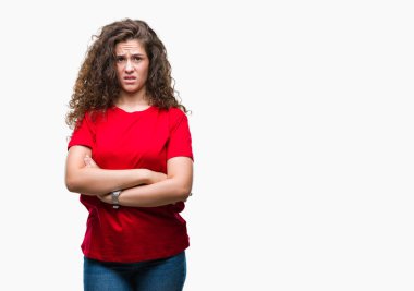 Güzel esmer kıvırcık saçlı Genç kız rahat giyiyor izole arka plan şüpheci ve sinir, onaylamayan ifade çapraz kolları olan yüzünde bak. Negatif kişi.