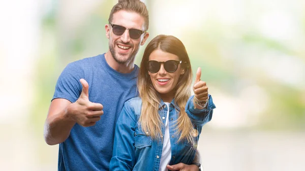 Young Couple Love Wearing Sunglasses Isolated Background Doing Happy Thumbs — Stock Photo, Image