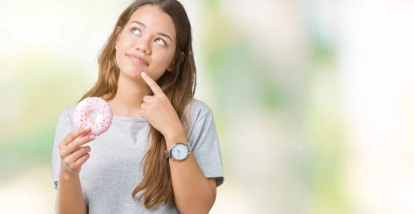 Joven Hermosa Mujer Comiendo Rosado Donut Sobre Aislado Fondo Serio —  Fotos de Stock