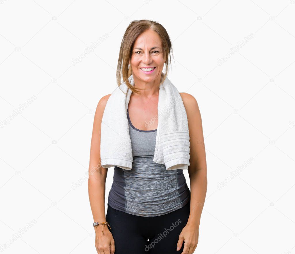 Beautiful middle age woman wearing sport clothes and a towel over isolated background with a happy and cool smile on face. Lucky person.