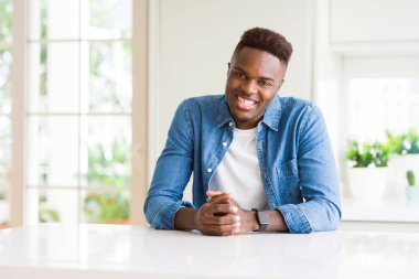 Afro-Amerikan yakışıklı evde yüzünde mutlu ve güzel bir gülümseme ile. Şanslı kişi.