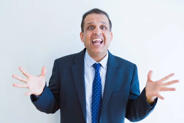 Middle age business man celebrating and screaming happy for succ — Stock Photo, Image