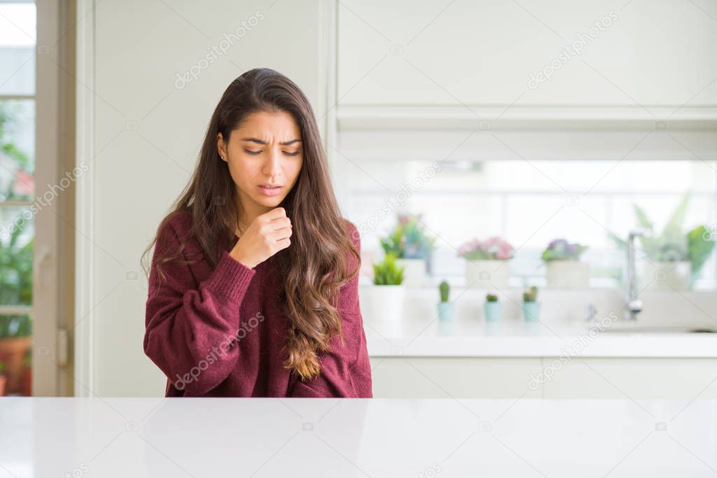 Young beautiful woman at home feeling unwell and coughing as symptom for cold or bronchitis. Healthcare concept.