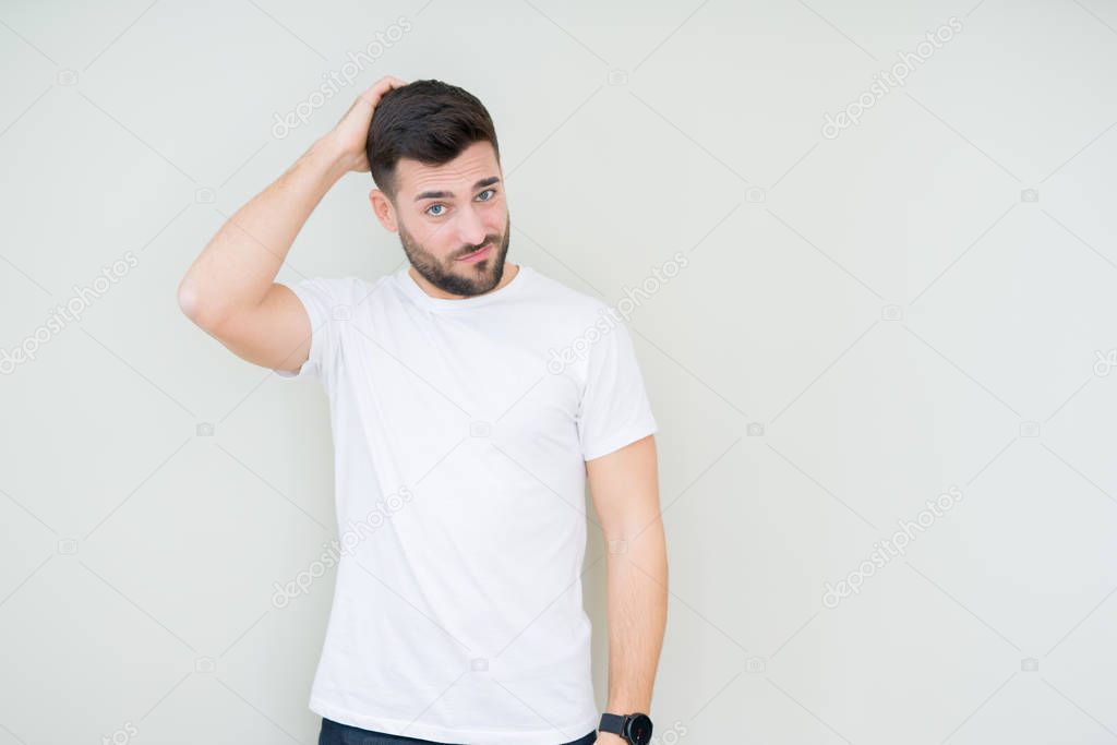 Young handsome man wearing casual white t-shirt over isolated background confuse and wonder about question. Uncertain with doubt, thinking with hand on head. Pensive concept.