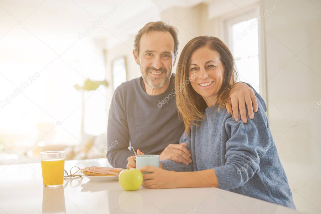 Beautiful romantic middle age couple having healthy breaskfast i
