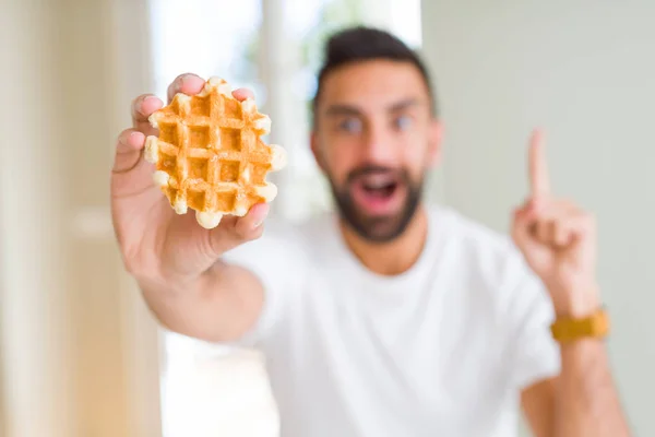 Handsome Hispanic Man Eating Sweet Belgian Waffle Pastry Surprised Idea — Stock Photo, Image