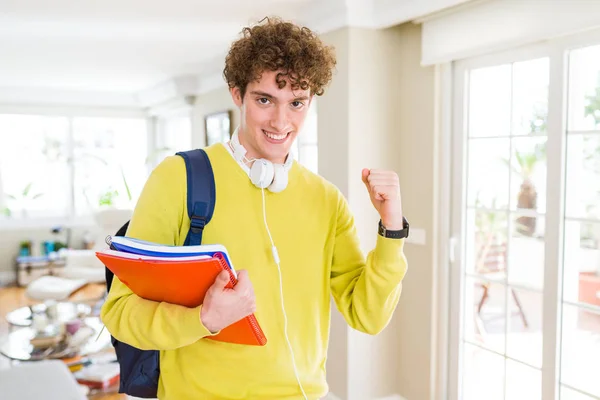 Young Student Man Wearing Headphones Backpack Holding Notebooks Screaming Proud — Stock Photo, Image