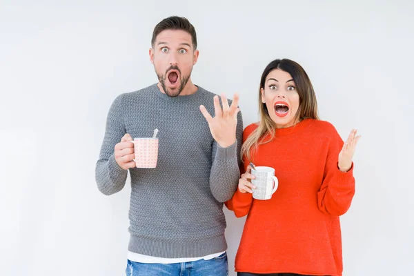 Jong Koppel Kopje Koffie Drinken Geïsoleerde Achtergrond Erg Blij Opgewonden — Stockfoto